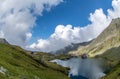 Balea lake and Balea Hotel in spring time with clouds Royalty Free Stock Photo